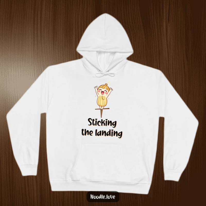 Funny hoodie depicting a noodle character excitedly doing a headstand on a chopstick, perfect for comfort.